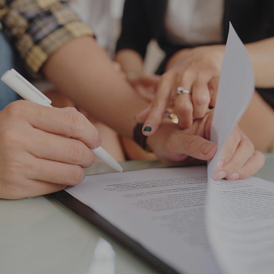 image of peole signing a gestational carrier agreement